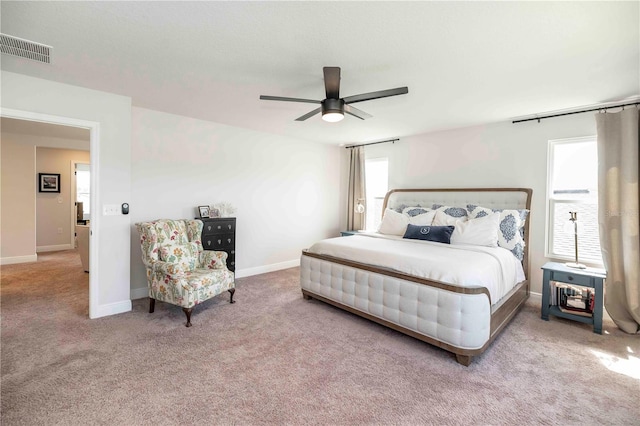 carpeted bedroom with ceiling fan, visible vents, and baseboards