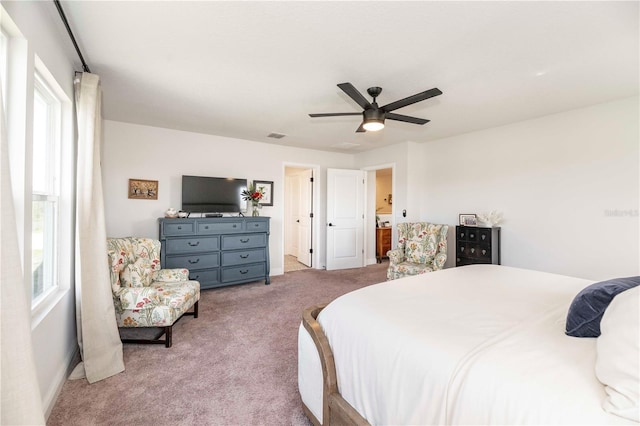 carpeted bedroom featuring multiple windows, a ceiling fan, and baseboards