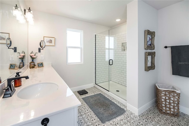 bathroom featuring a shower stall, baseboards, and a sink