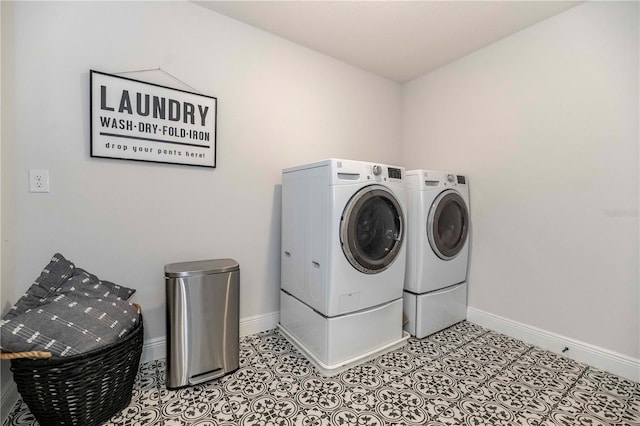 laundry room with laundry area, baseboards, and washer and dryer