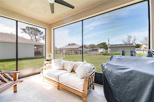 sunroom / solarium featuring ceiling fan