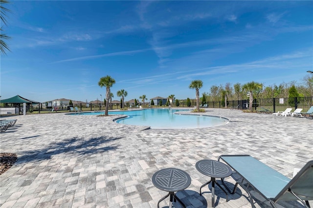 pool featuring a patio area and fence