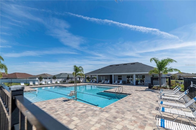 pool featuring fence and a patio