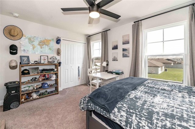 bedroom with ceiling fan, a closet, and carpet flooring