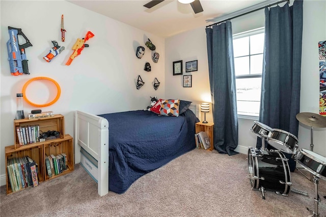 bedroom with a ceiling fan, multiple windows, and carpet flooring