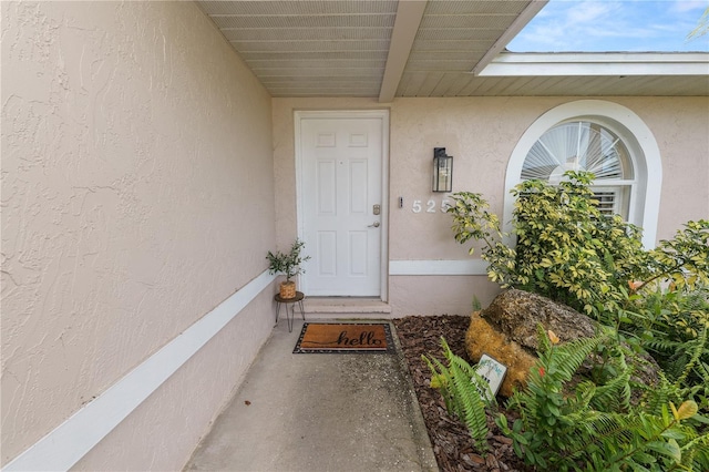 property entrance featuring stucco siding