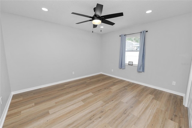 unfurnished room with light wood-style floors, recessed lighting, and baseboards