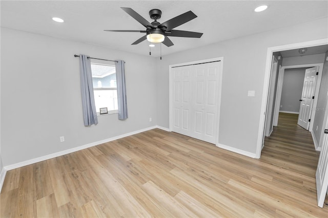 unfurnished bedroom with light wood-type flooring, baseboards, and recessed lighting