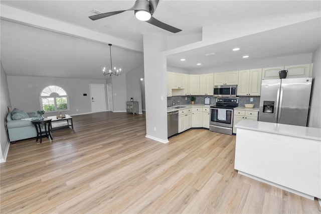 kitchen with open floor plan, vaulted ceiling with beams, light countertops, stainless steel appliances, and backsplash