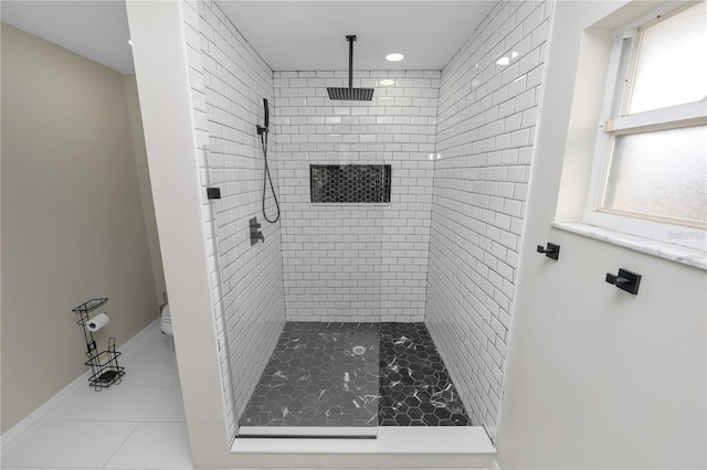 full bathroom featuring toilet, a shower stall, baseboards, and tile patterned flooring