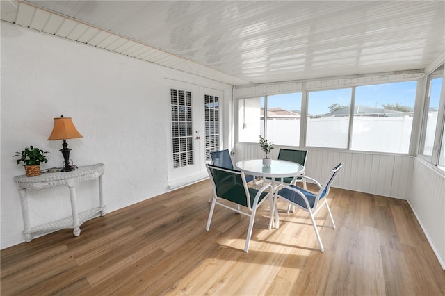 sunroom featuring french doors and a healthy amount of sunlight