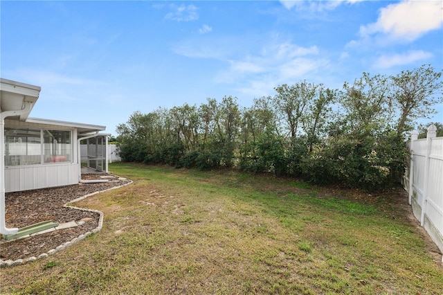 view of yard featuring a sunroom and fence