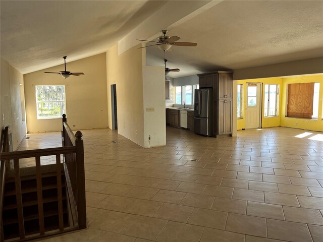 330 Callitris Ave, Polk City, FL 33868 - living room with lofted ceiling, a textured ceiling, and tile patterned floors
