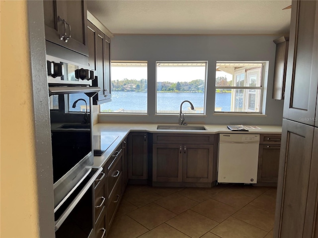 330 Callitris Ave, Polk City, FL 33868 - kitchen featuring dishwasher, oven, light countertops, a healthy amount of sunlight, and a sink