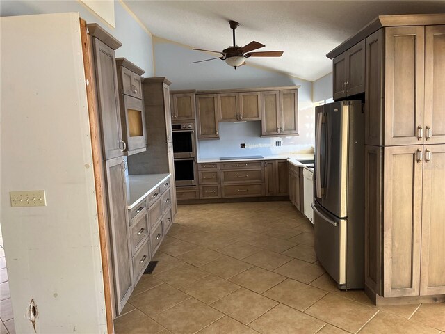 330 Callitris Ave, Polk City, FL 33868 - kitchen with light tile patterned floors, a ceiling fan, vaulted ceiling, light countertops, and appliances with stainless steel finishes