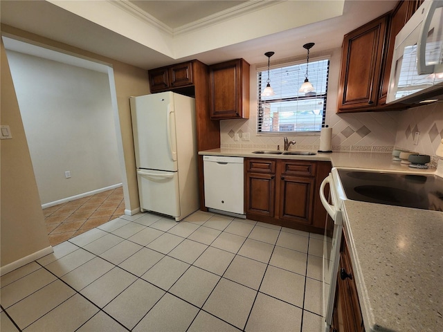 kitchen with light tile patterned floors, white appliances, a sink, decorative backsplash, and a raised ceiling