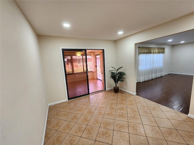 spare room featuring light tile patterned floors, baseboards, and recessed lighting