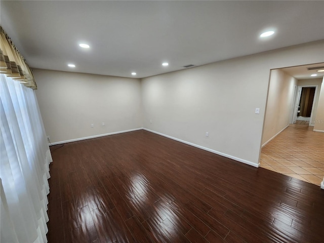 unfurnished room with wood finished floors, visible vents, and recessed lighting