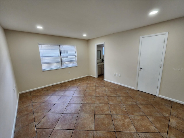 spare room with baseboards, recessed lighting, and tile patterned floors