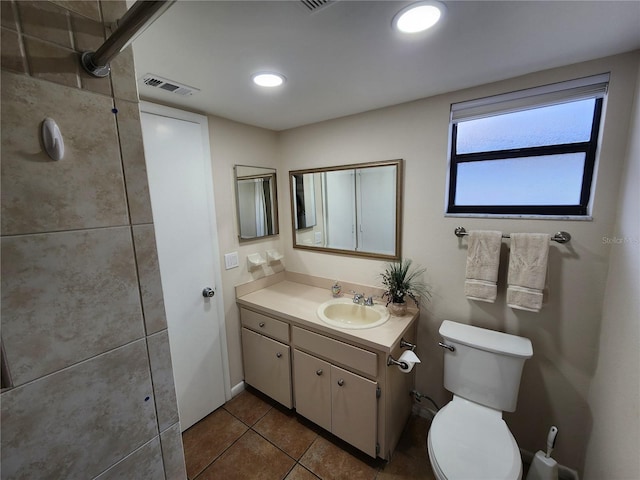 bathroom with toilet, tile patterned flooring, visible vents, and vanity