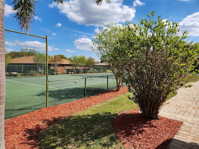 view of tennis court featuring fence