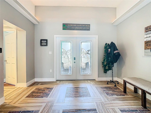 foyer entrance with french doors and baseboards