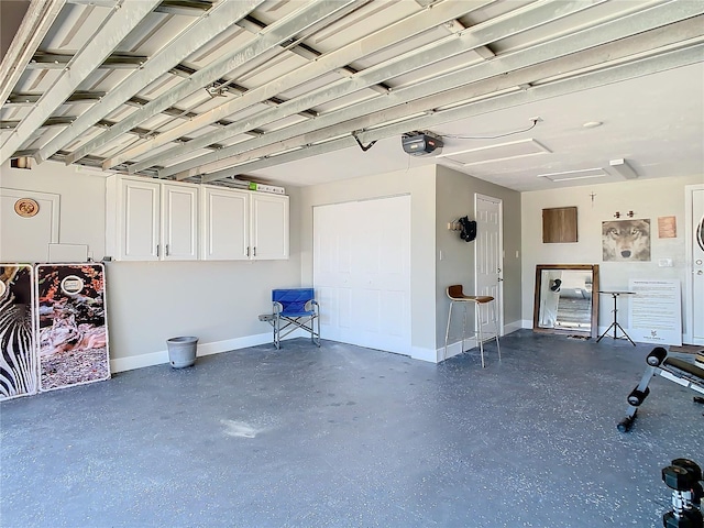 garage with a garage door opener and baseboards