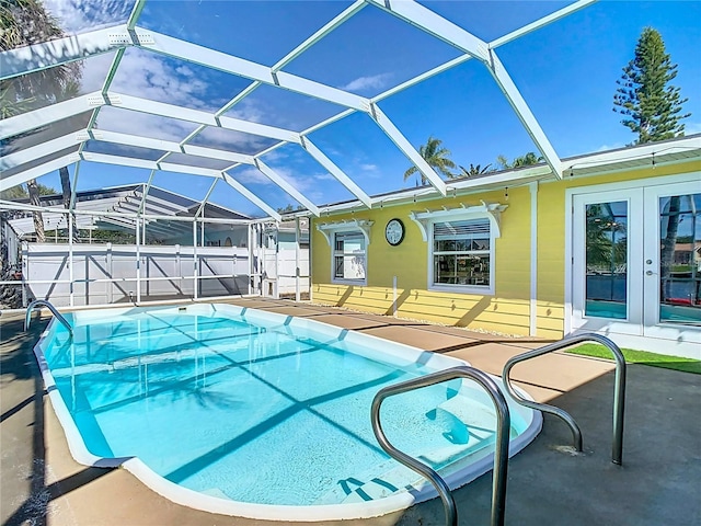 view of swimming pool with a patio, french doors, a lanai, and a fenced in pool