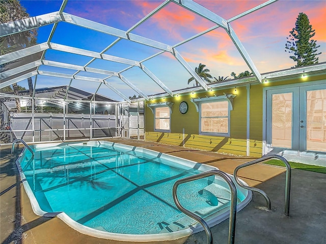 view of swimming pool with a fenced in pool, glass enclosure, and a patio