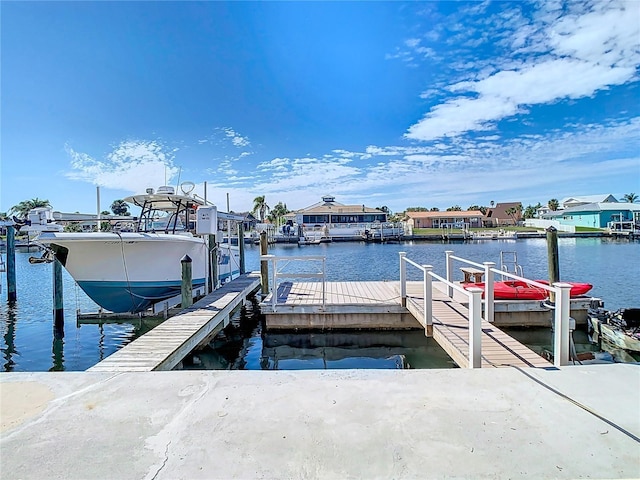 dock area with a water view and boat lift