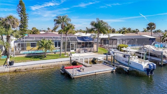 dock area with a lanai, a water view, an outdoor pool, and boat lift