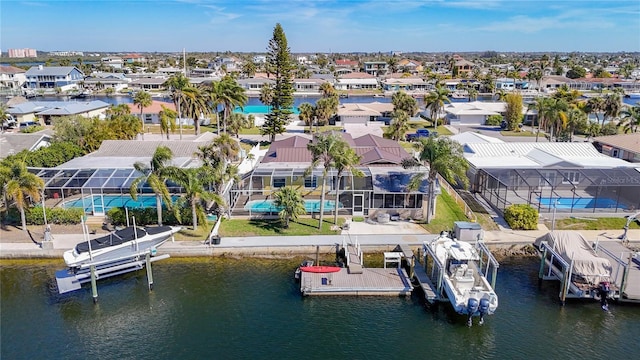 birds eye view of property with a water view and a residential view