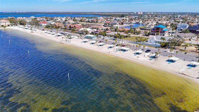 birds eye view of property with a view of the beach and a water view