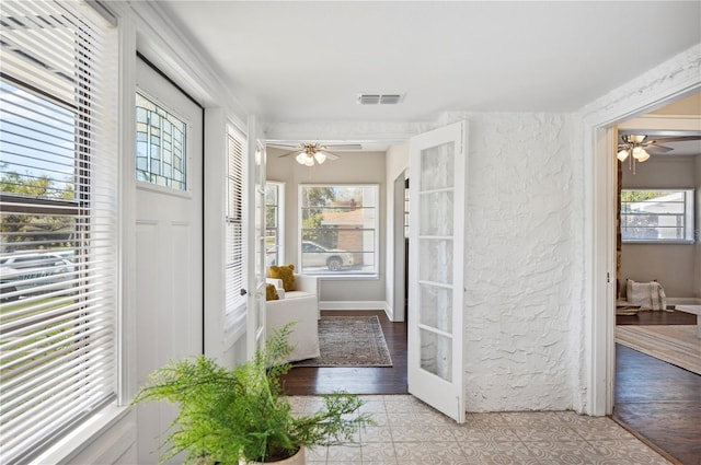 interior space with plenty of natural light, visible vents, and a ceiling fan