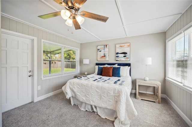 bedroom featuring ceiling fan, multiple windows, and carpet flooring