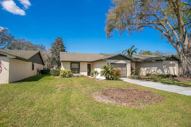 ranch-style house featuring stucco siding, concrete driveway, a garage, and a front yard