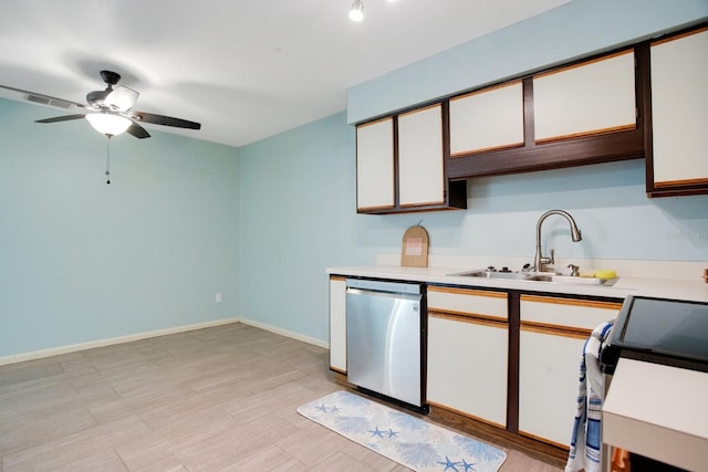 kitchen with dishwasher, light countertops, a sink, and baseboards