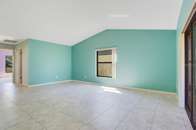 unfurnished room with lofted ceiling, visible vents, baseboards, and light tile patterned flooring