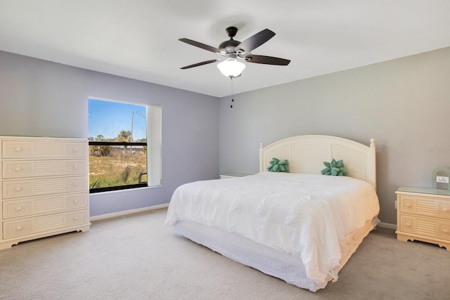 bedroom with carpet flooring, a ceiling fan, and baseboards