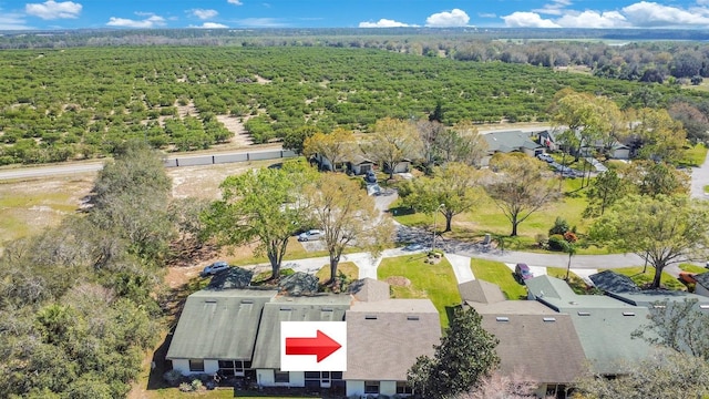 birds eye view of property with a view of trees