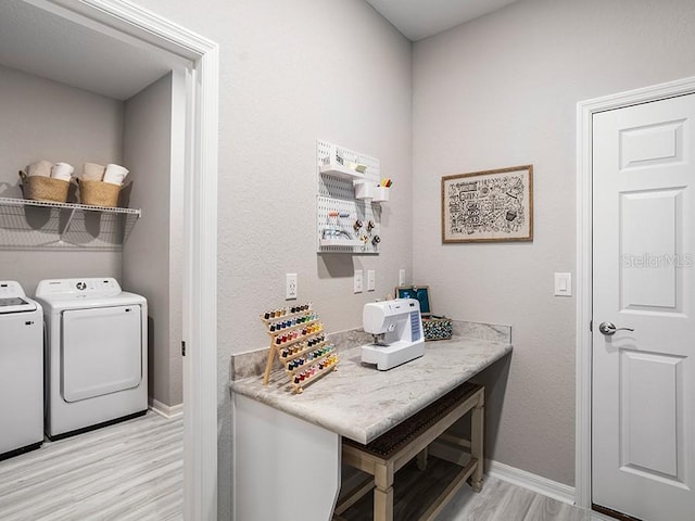 laundry area featuring light wood-style flooring, laundry area, washer and clothes dryer, and baseboards