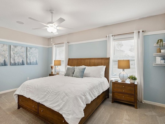 carpeted bedroom featuring ceiling fan and baseboards