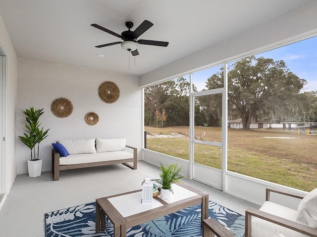 sunroom / solarium featuring a ceiling fan