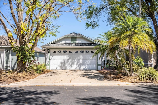 ranch-style house featuring driveway and a garage