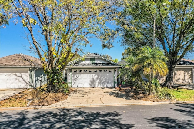 view of front facade with concrete driveway and an attached garage