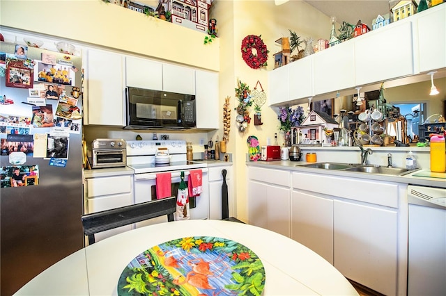 kitchen with a toaster, light countertops, white cabinetry, a sink, and white appliances