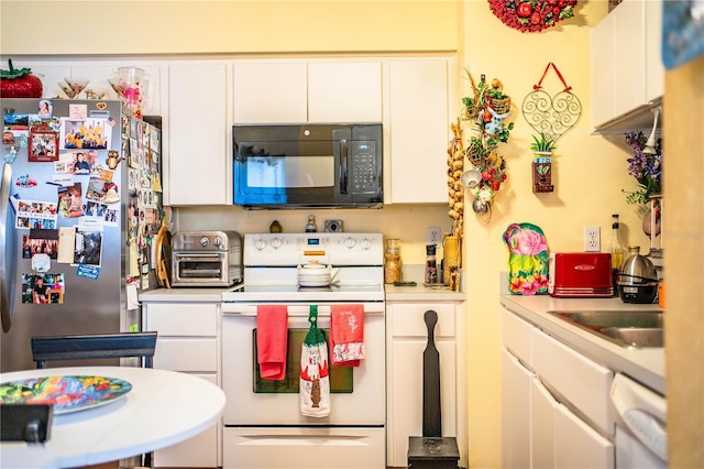 kitchen with white appliances, a toaster, white cabinets, and light countertops