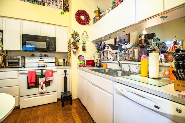 kitchen with a toaster, white appliances, a sink, light countertops, and dark wood finished floors