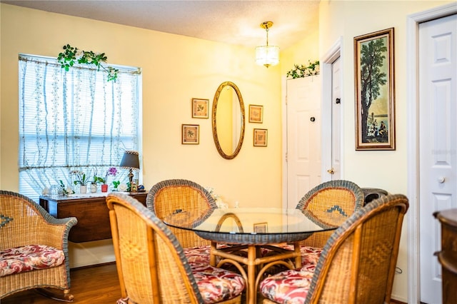 dining space with wood finished floors