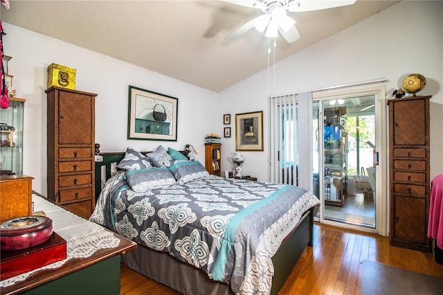 bedroom featuring access to exterior, vaulted ceiling, hardwood / wood-style floors, and a ceiling fan